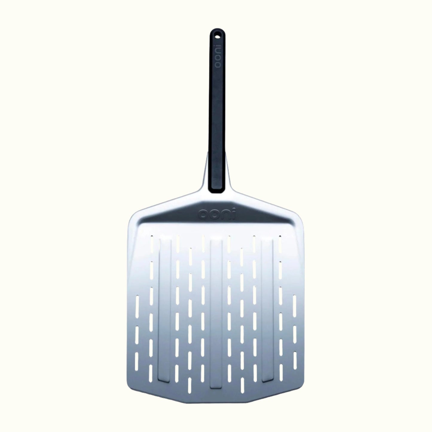 The Ooni 12-Inch Perforated Pizza Peel on an Off-White Background