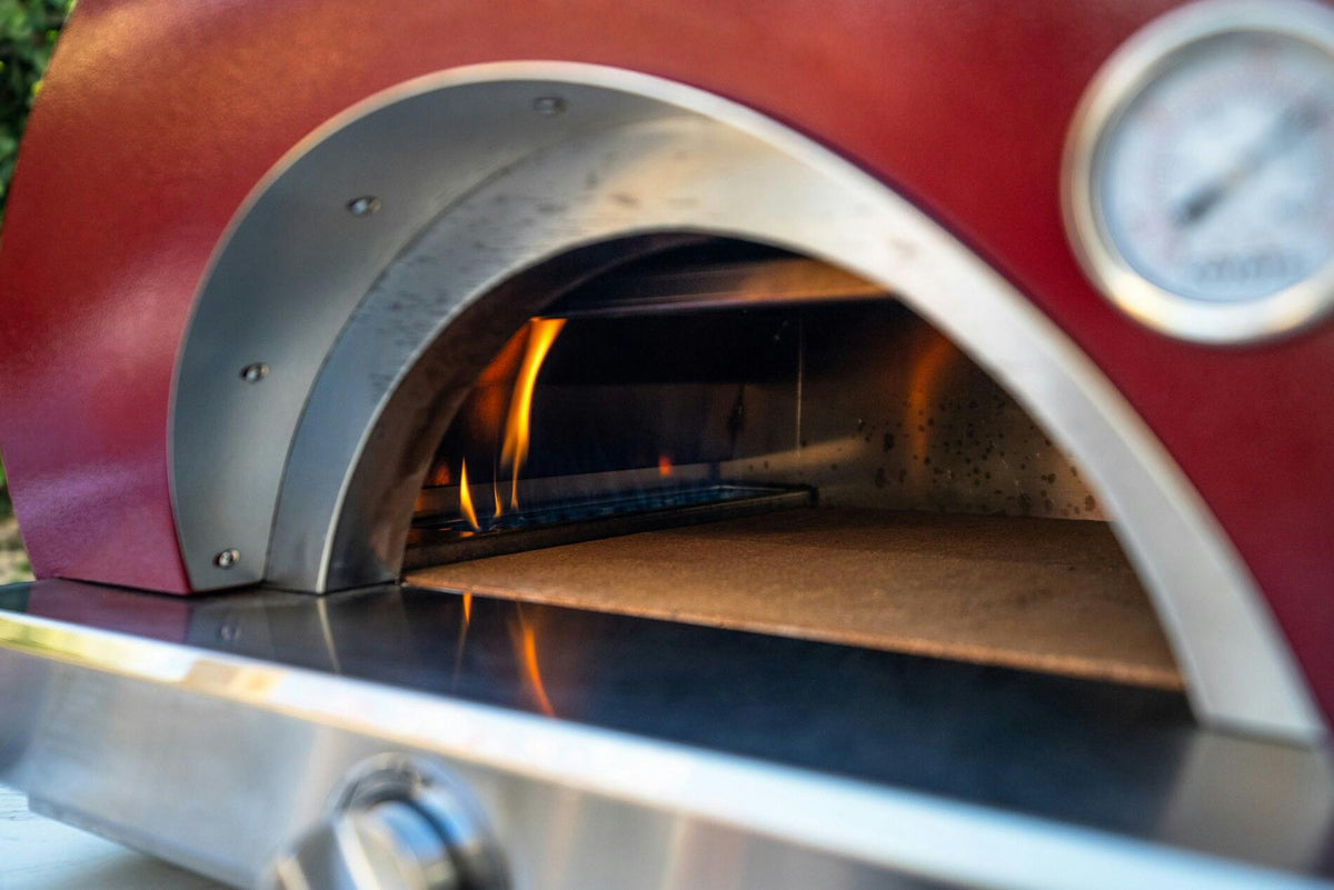 Coyote Hybrid Multi-Fuel Pizza Oven in use with live fire