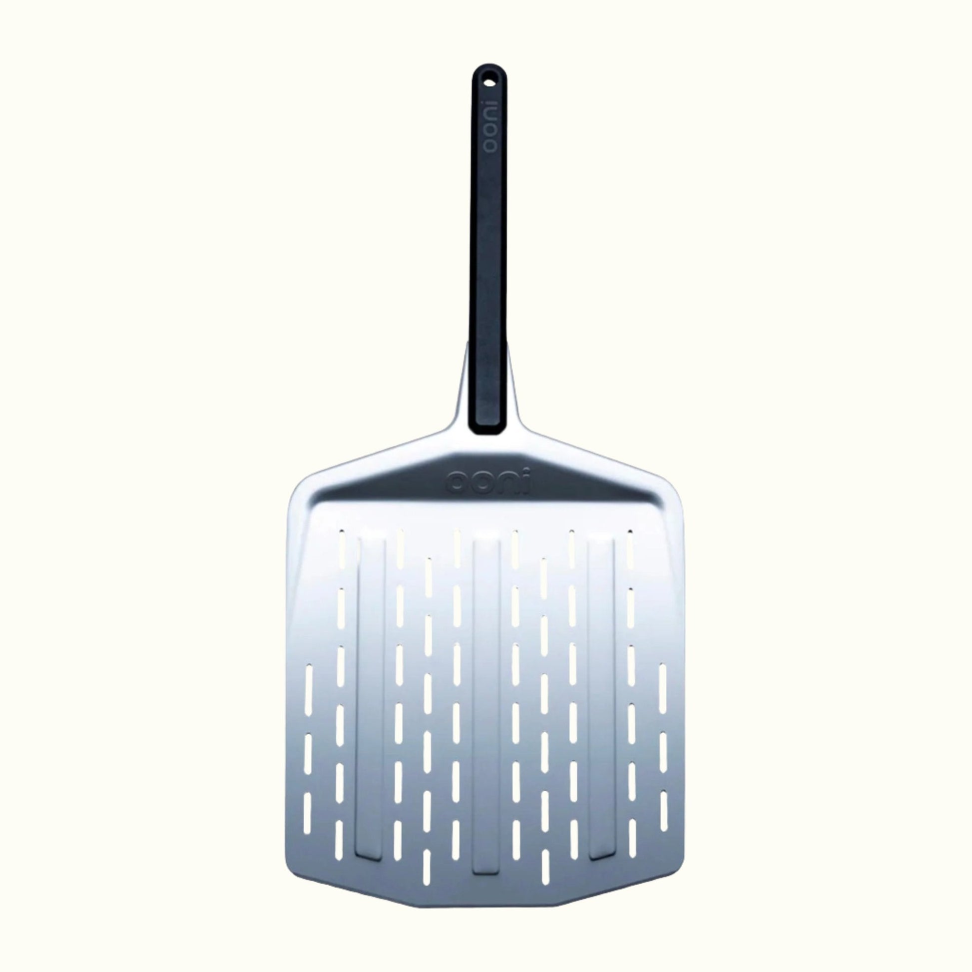 The Ooni 12-Inch Perforated Pizza Peel on an Off-White Background